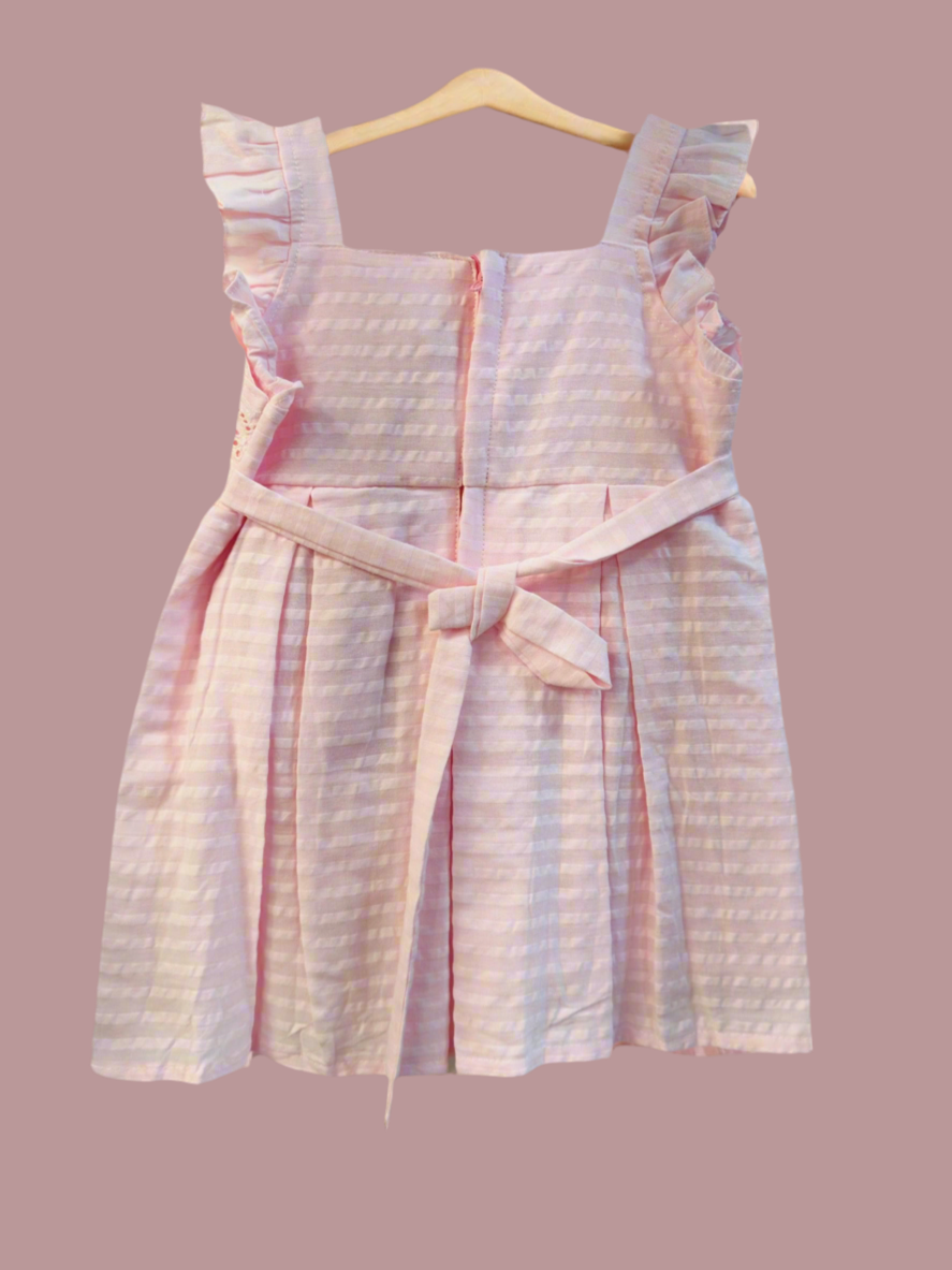 Luxe thread soft cotton infant dress in pink with ruffle straps and a tied waist detail