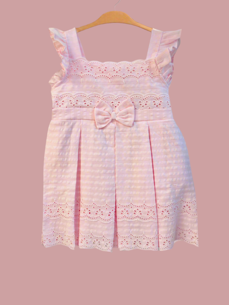 Luxe Thread soft cotton infant dress in pink with ruffled sleeves and a bow detail